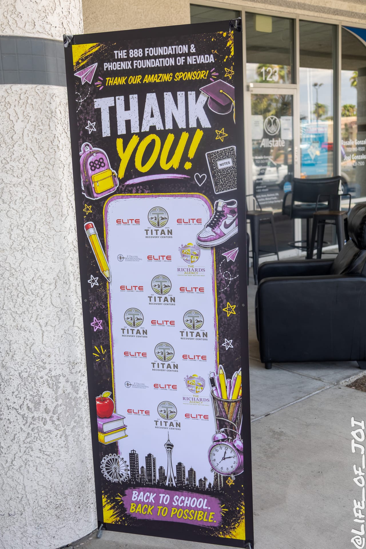 The 888 Foundation and Phoenix Foundation of Nevada sponsor banner outside The Blade Barber Lounge, reading Back to School, Back to Possible.