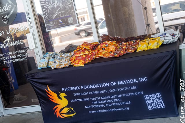 The Phoenix Foundation of Nevada table with free food and refreshments set up inside the lounge for families.
